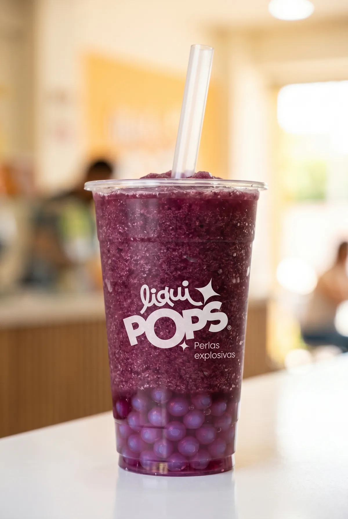 Granizado morado azulado con perlas explosivas LiquiPops — vaso sobre mesa de madera