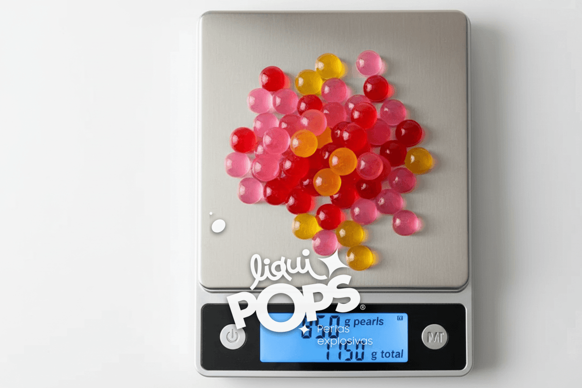 Top-down close-up of a precision scale showing a drained portion of popping boba pearls on a stainless steel tray: digit.