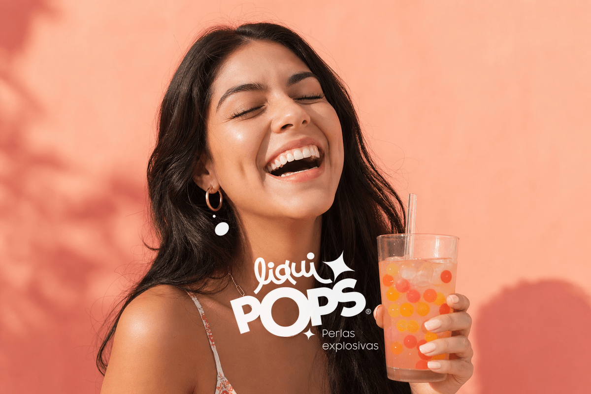 Macro overhead photography of a wide-open mouth (no face visible, just the lips and tongue) with multicolor popping boba.
